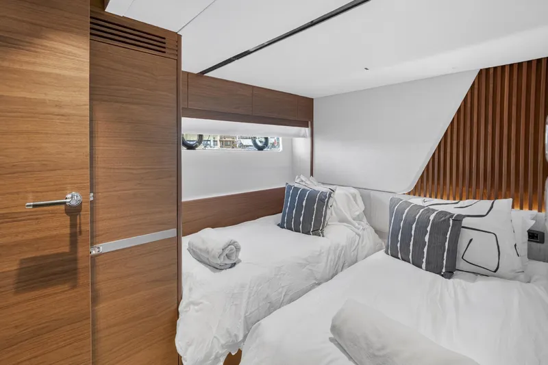  Yacht Photos Pics Luxurious cabin interior of 2022 Princess Y85 yacht with twin beds and modern decor.