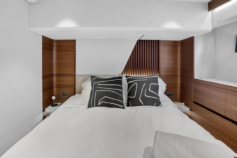  Yacht Photos Pics Luxurious bedroom interior of 2022 Princess Y85 yacht with modern design and elegant wood accents.