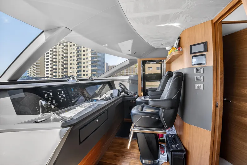  Yacht Photos Pics Luxurious 2022 Princess Y85 yacht cockpit with modern controls and leather seating.