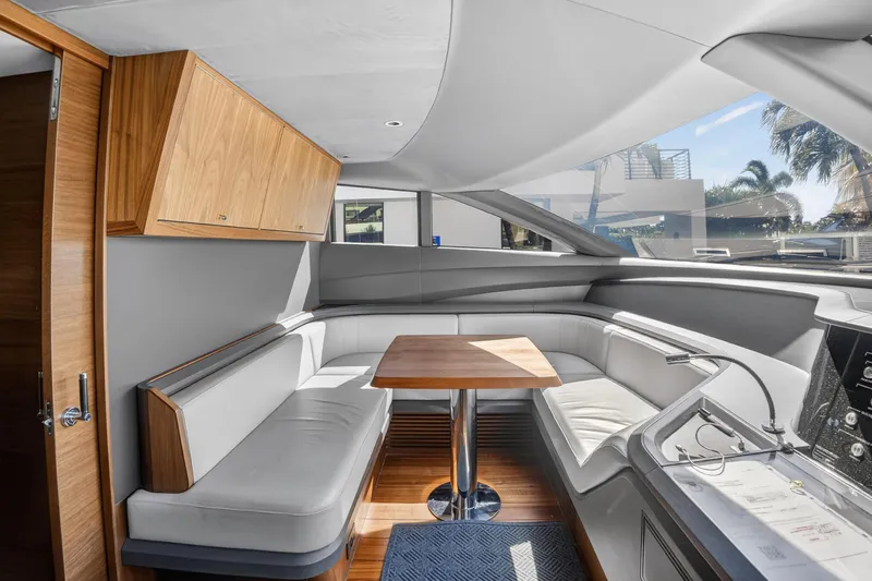  Yacht Photos Pics Luxurious interior of 2022 Princess Y85 yacht with sleek seating and wooden accents.