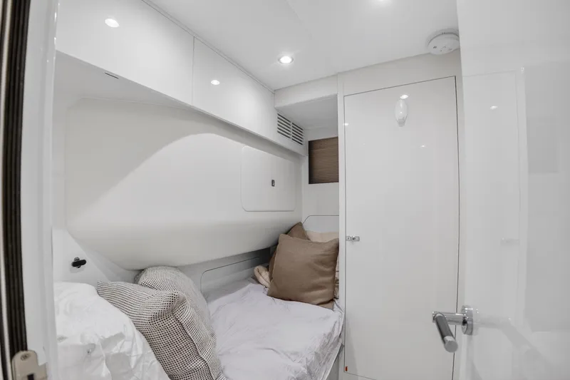  Yacht Photos Pics Luxurious cabin interior of 2022 Princess Y85 yacht, featuring cozy bedding and modern design.