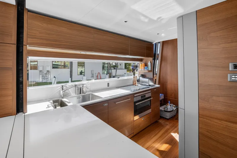  Yacht Photos Pics Luxurious kitchen interior of 2022 Princess Y85 yacht with modern wood cabinetry.