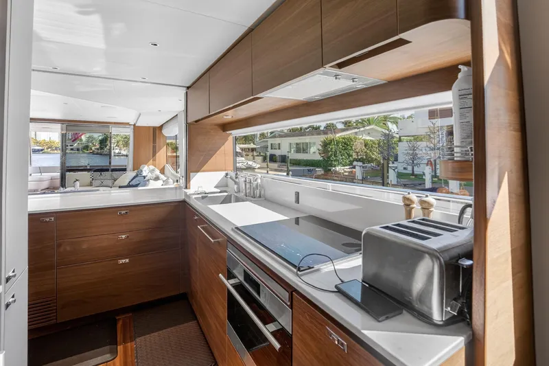  Yacht Photos Pics Luxurious kitchen interior of 2022 Princess Y85 yacht with modern appliances and sleek design.