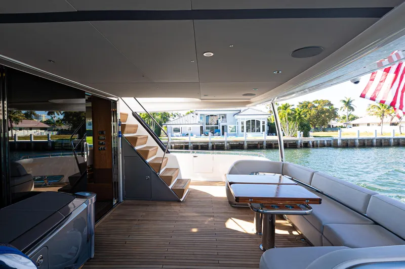  Yacht Photos Pics Luxurious 2022 Princess Y85 yacht deck with seating, table, and waterfront view.