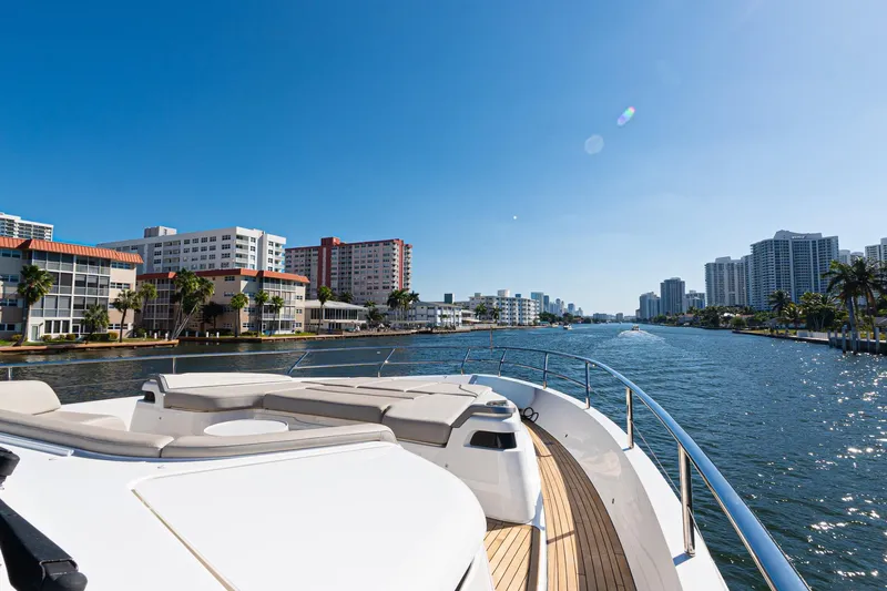  Yacht Photos Pics Luxurious 2022 Princess Y85 yacht cruising along a scenic urban waterfront.