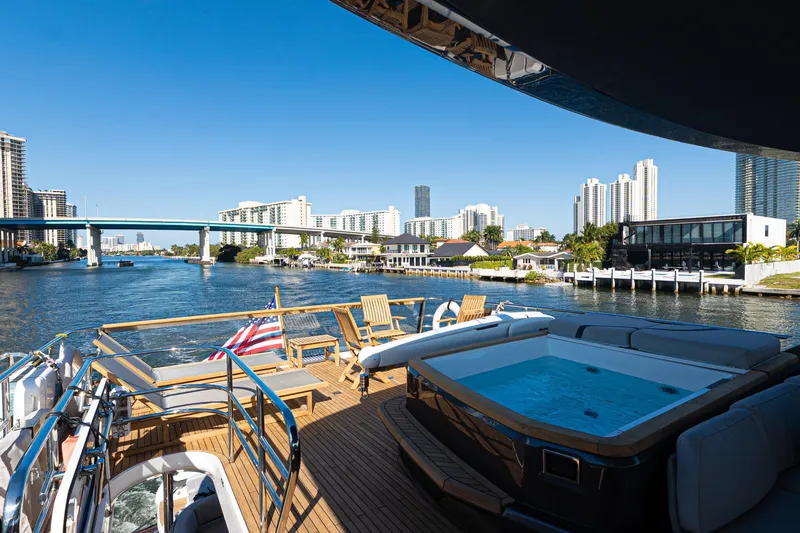  Yacht Photos Pics Luxurious 2022 Princess Y85 yacht with hot tub, cruising in a scenic urban waterway.
