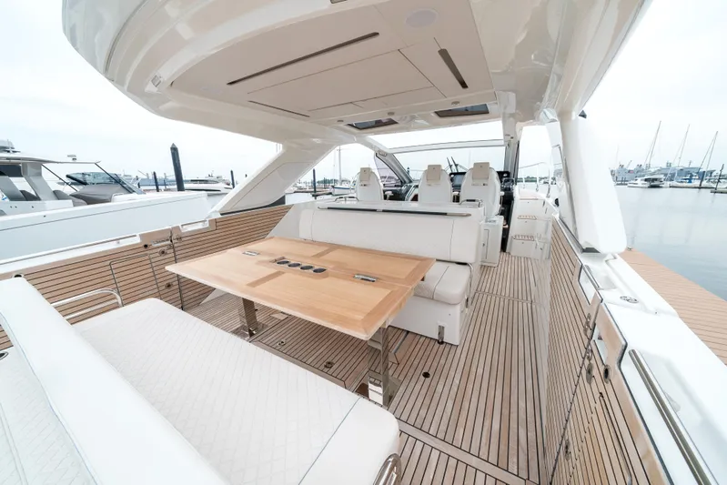 Yacht Photos Pics 2024 Jeanneau DB43 Outboard luxury yacht interior with elegant seating and wooden table.