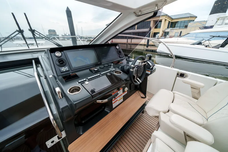  Yacht Photos Pics 2024 Jeanneau DB43 Outboard helm with modern controls and luxurious seating.