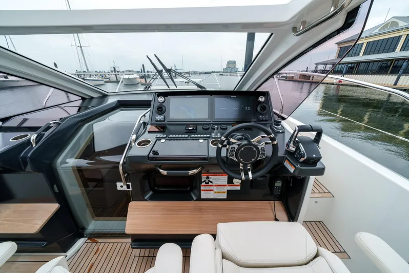  Yacht Photos Pics 2024 Jeanneau DB43 Outboard helm with modern controls and navigation screens.