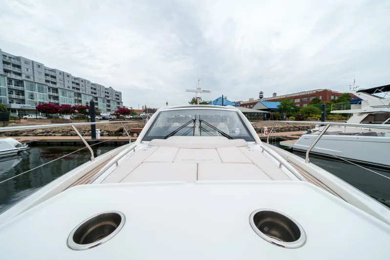  Yacht Photos Pics 2024 Jeanneau DB43 Outboard yacht docked at marina, cityscape background.