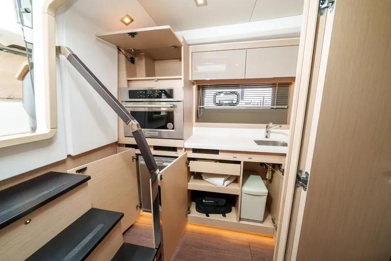  Yacht Photos Pics 2024 Jeanneau DB43 Outboard interior kitchen with modern appliances and sleek design.