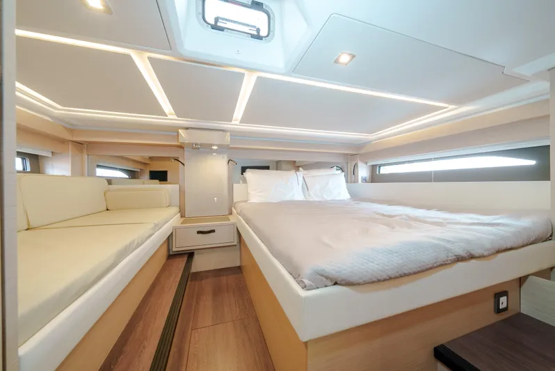  Yacht Photos Pics Luxurious interior of 2024 Jeanneau DB43 Outboard with spacious bed and modern lighting.