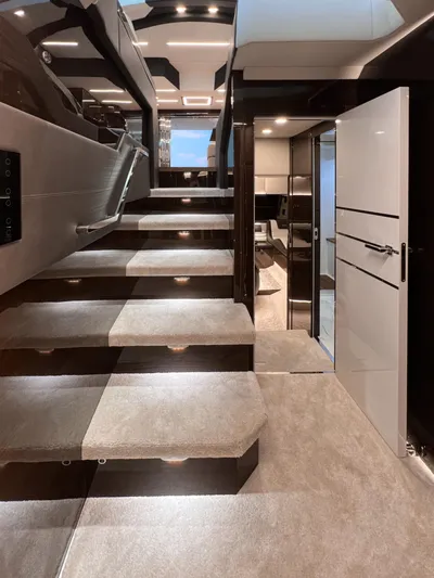 Custom Order Yours Today! Yacht Photos Pics Luxurious interior of 2026 Cobrey 52 Hardtop yacht with modern staircase and elegant design.