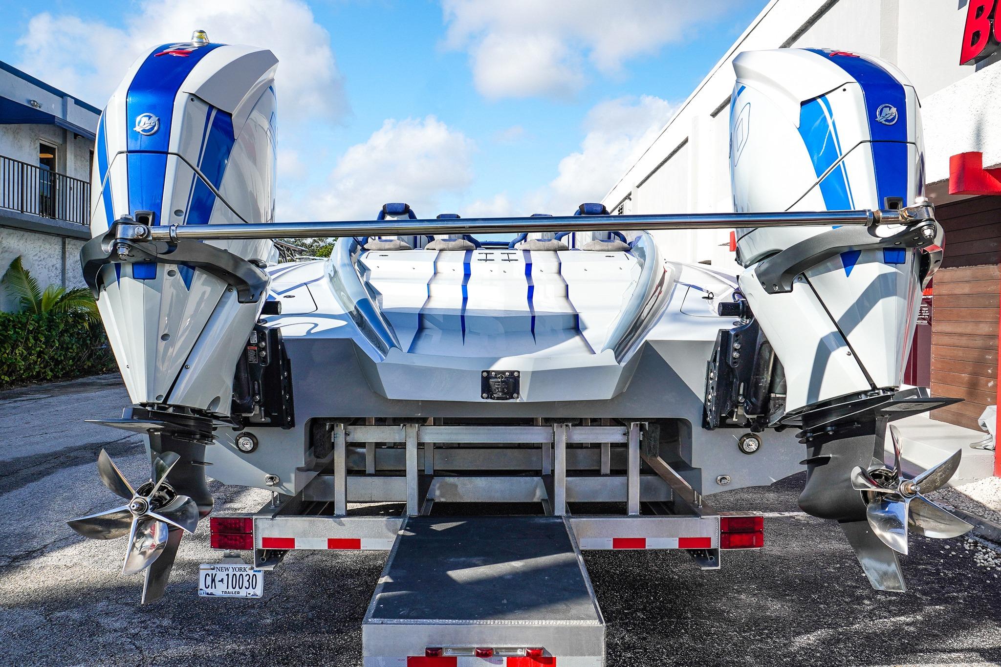 2026 Statement 396 boat with dual outboard motors on a trailer, rear view.