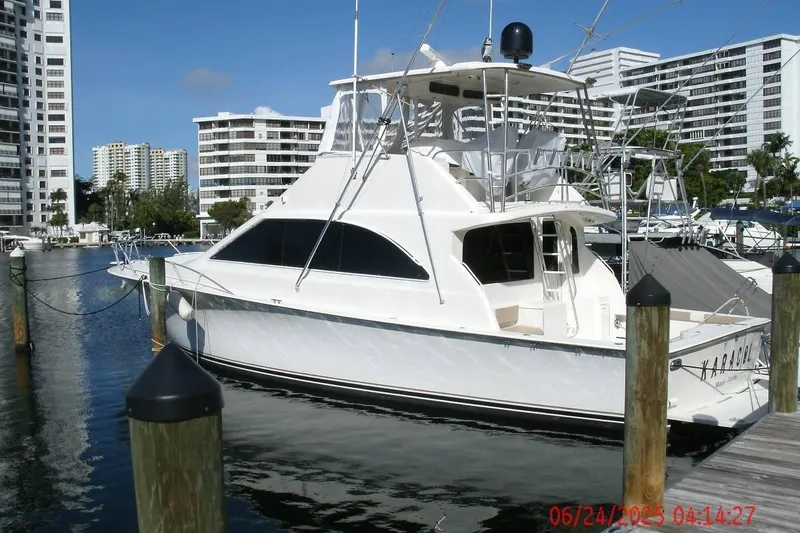  Yacht Photos Pics 1998 Ocean Yachts 48 Super Sport docked in a marina with modern buildings in the background.