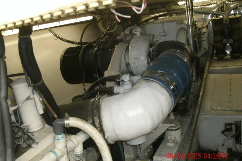 Yacht Photos Pics Engine room of a 1998 Ocean Yachts 48 Super Sport, showcasing mechanical components and piping.