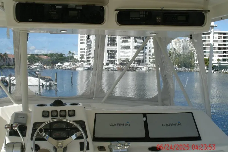  Yacht Photos Pics Cockpit view of 1998 Ocean Yachts 48 Super Sport with Garmin navigation, overlooking marina.