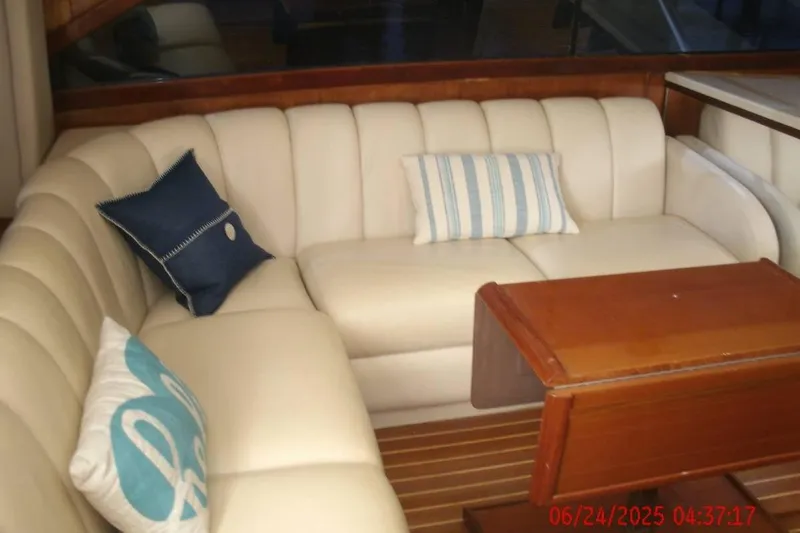  Yacht Photos Pics Luxurious interior of 1998 Ocean Yachts 48 Super Sport with plush seating and wooden table.