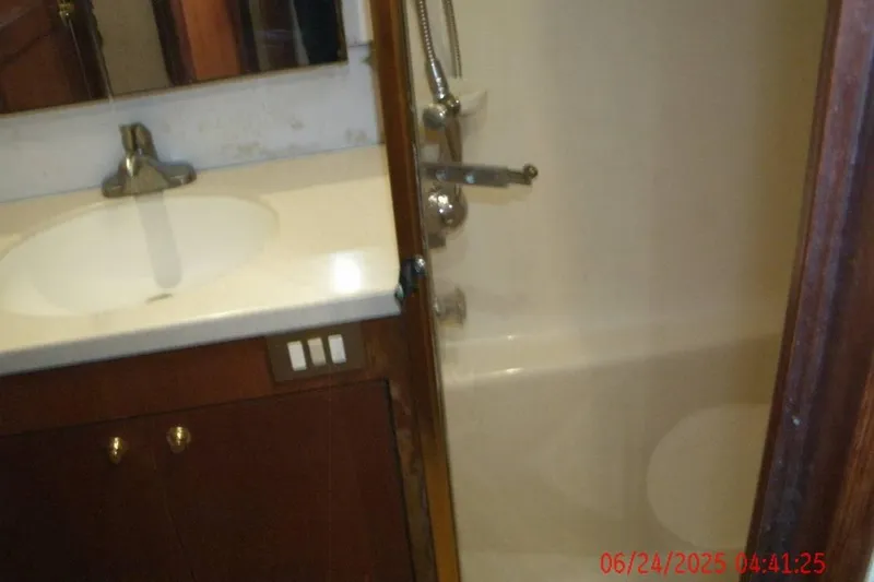  Yacht Photos Pics Bathroom interior of 1998 Ocean Yachts 48 Super Sport, featuring sink and shower.