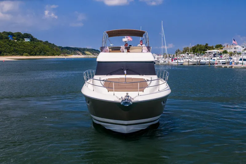 Passion Play Yacht Photos Pics 2014 Prestige Yachts 550 Flybridge cruising in a scenic marina setting.