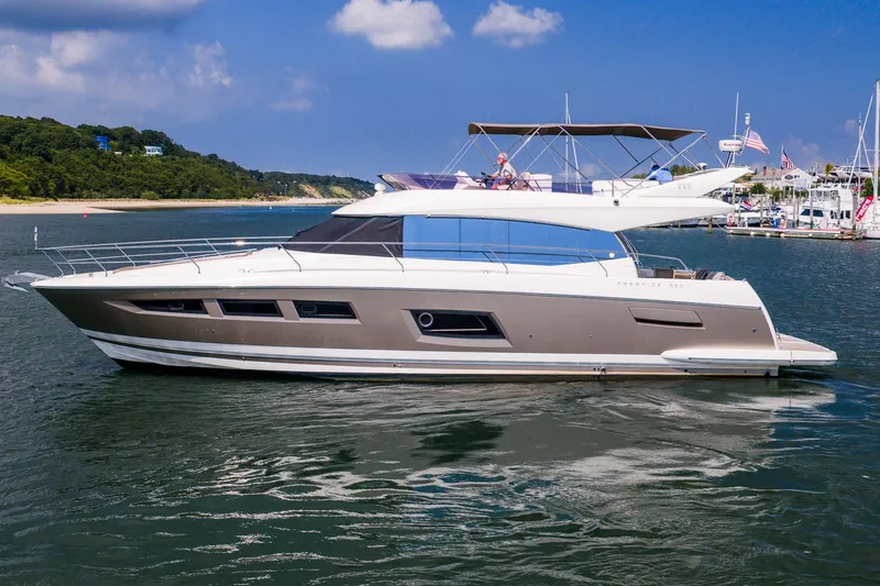 Passion Play Yacht Photos Pics 2014 Prestige Yachts 550 Flybridge cruising on a scenic waterway.