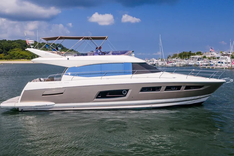 Passion Play Yacht Photos Pics 2014 Prestige Yachts 550 Flybridge cruising on a sunny day near a marina.