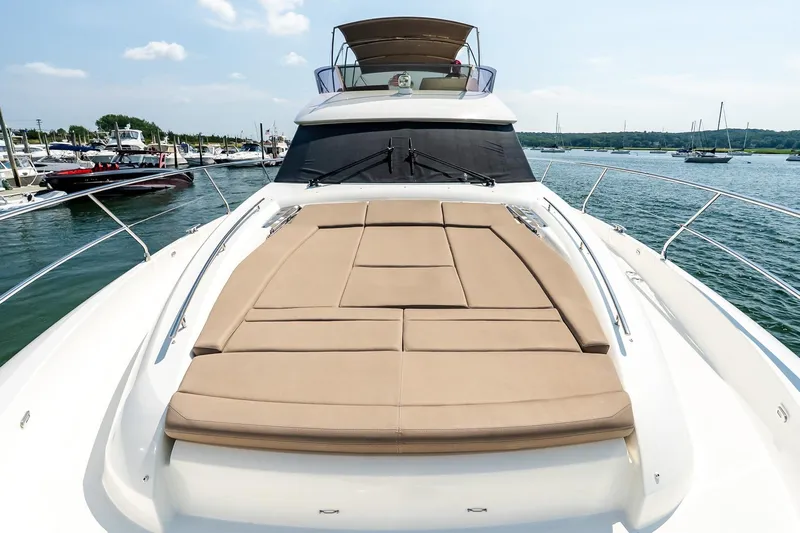 Passion Play Yacht Photos Pics 2014 Prestige Yachts 550 Flybridge with sunbathing deck, docked in a marina.