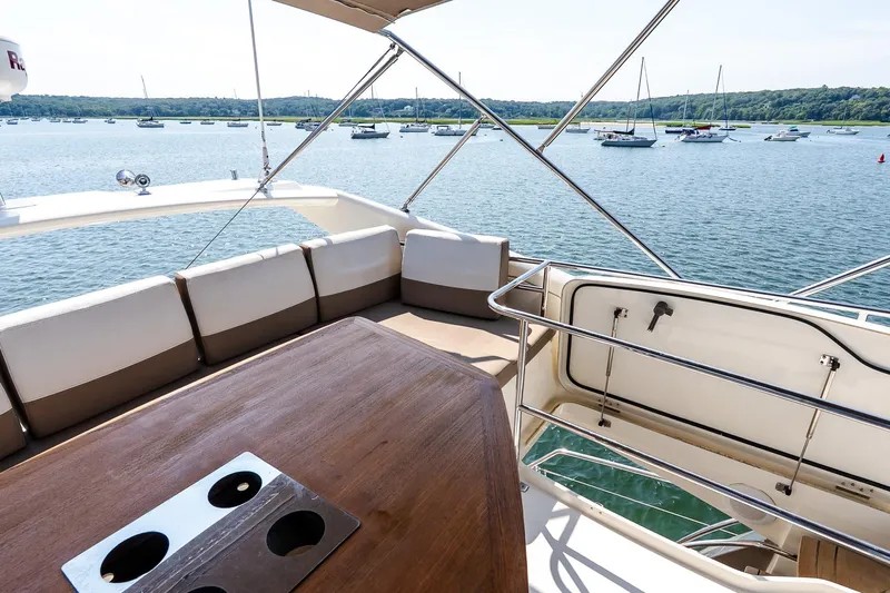 Passion Play Yacht Photos Pics Flybridge view on 2014 Prestige Yachts 550, overlooking serene waters and anchored boats.