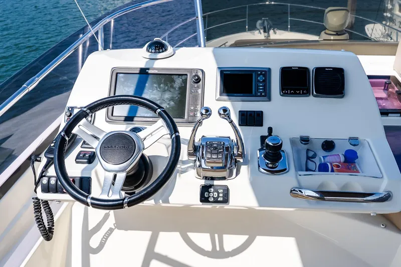 Passion Play Yacht Photos Pics Flybridge helm of 2014 Prestige Yachts 550, featuring advanced navigation controls.