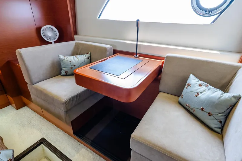 Passion Play Yacht Photos Pics Luxurious seating area on 2014 Prestige Yachts 550 Flybridge with elegant cushions and table.