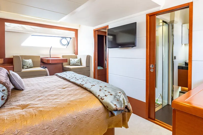 Passion Play Yacht Photos Pics Luxurious 2014 Prestige Yachts 550 Flybridge bedroom with elegant decor and ensuite bathroom.