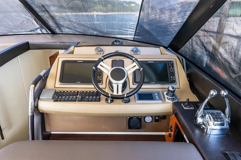 Passion Play Yacht Photos Pics 2014 Prestige Yachts 550 Flybridge helm with modern navigation controls and steering wheel.