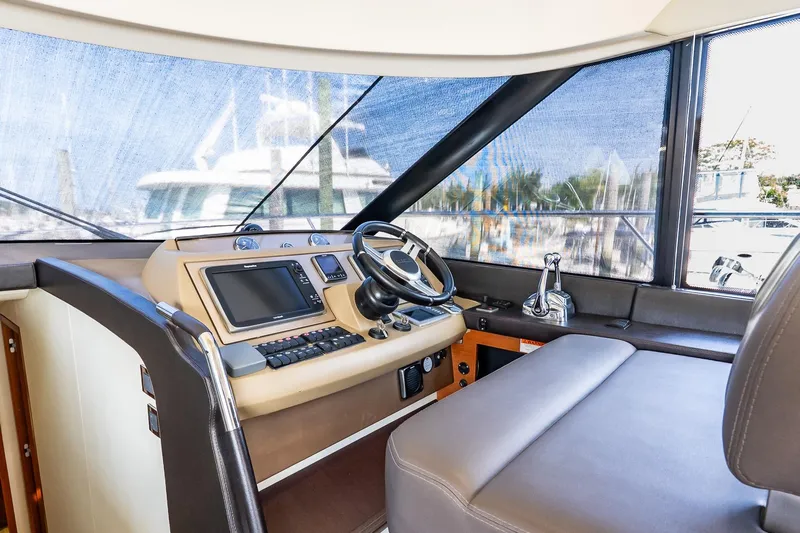 Passion Play Yacht Photos Pics Interior helm of 2014 Prestige Yachts 550 Flybridge, featuring modern navigation equipment.