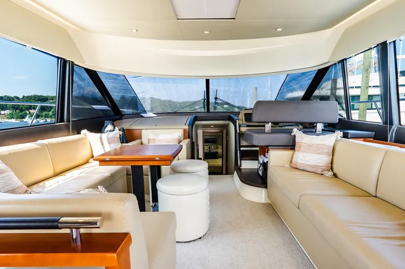 Passion Play Yacht Photos Pics Luxurious interior of 2014 Prestige Yachts 550 Flybridge with elegant seating and panoramic windows.