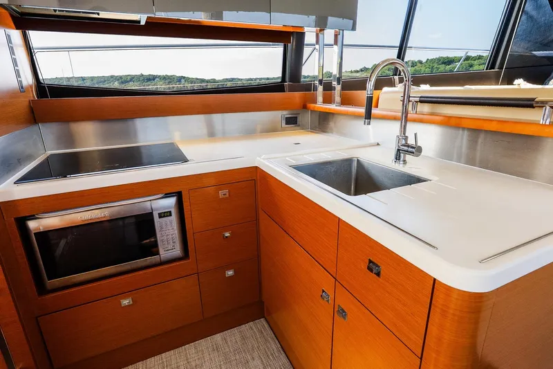 Passion Play Yacht Photos Pics Luxurious kitchen on 2014 Prestige Yachts 550 Flybridge with modern appliances and sleek design.