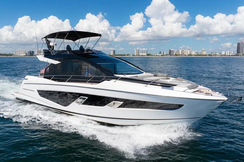  Yacht Photos Pics 2023 Sunseeker 65 Sport Yacht cruising on open water under a clear sky.