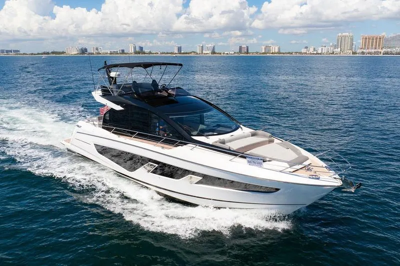  Yacht Photos Pics 2023 Sunseeker 65 Sport Yacht cruising on open water under a clear sky.