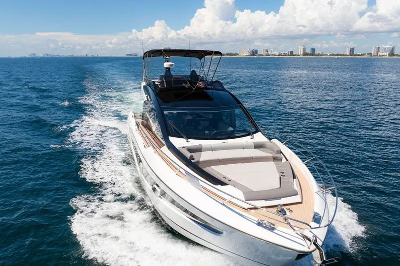  Yacht Photos Pics 2023 Sunseeker 65 Sport Yacht cruising on open water under a clear sky.