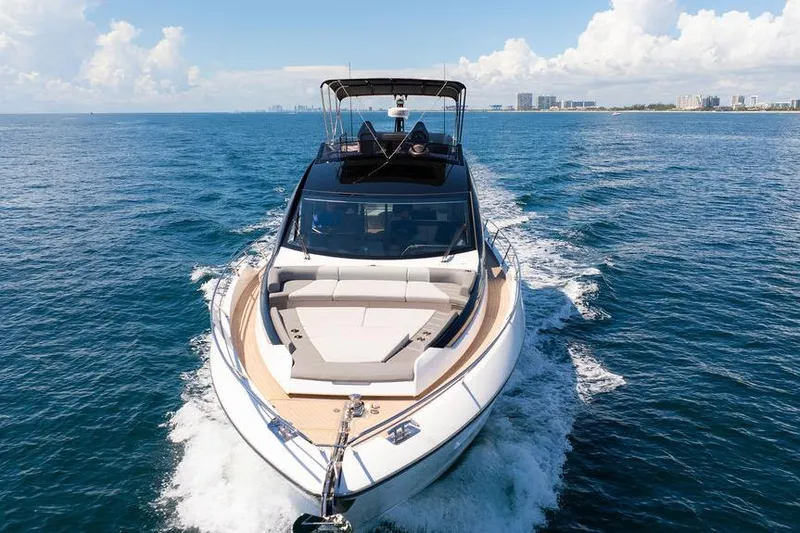  Yacht Photos Pics 2023 Sunseeker 65 Sport Yacht cruising on open water under clear skies.