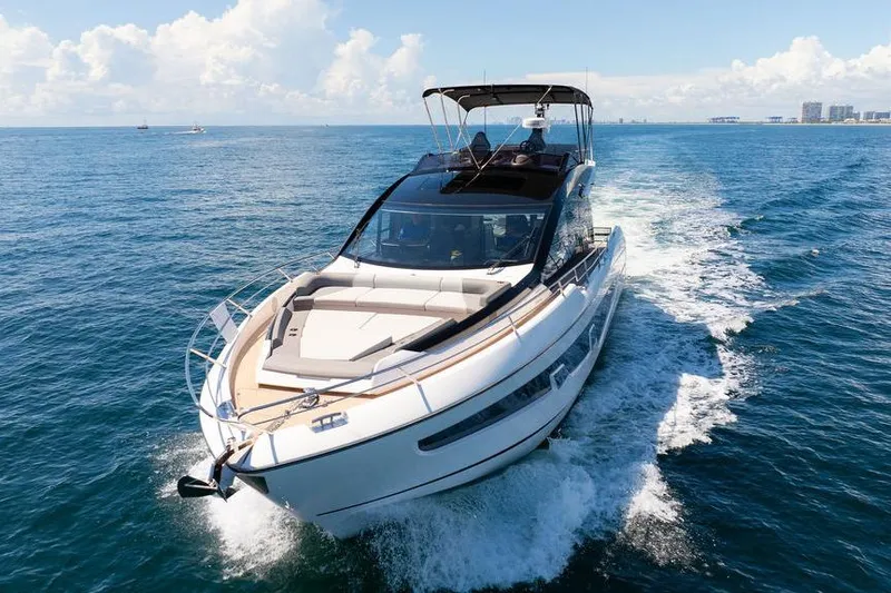  Yacht Photos Pics 2023 Sunseeker 65 Sport Yacht cruising on open sea under clear skies.