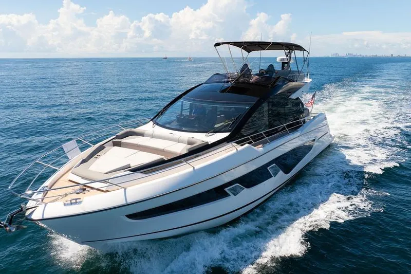  Yacht Photos Pics 2023 Sunseeker 65 Sport Yacht cruising on open sea under clear skies.