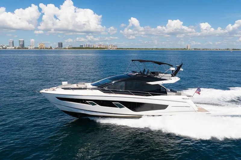  Yacht Photos Pics 2023 Sunseeker 65 Sport Yacht cruising on open water under a clear sky.