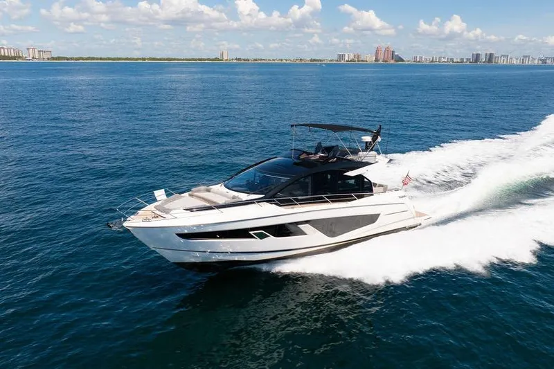  Yacht Photos Pics 2023 Sunseeker 65 Sport Yacht cruising on open water under a clear sky.