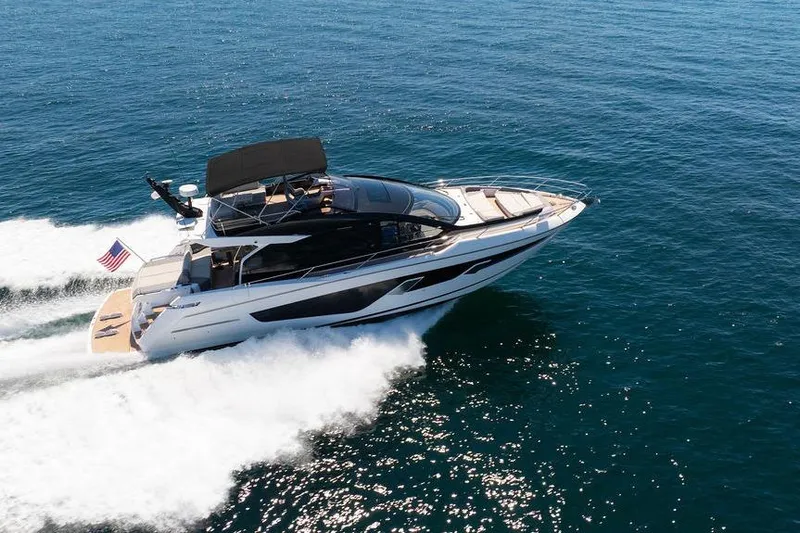  Yacht Photos Pics 2023 Sunseeker 65 Sport Yacht cruising on open water, showcasing sleek design and luxury.