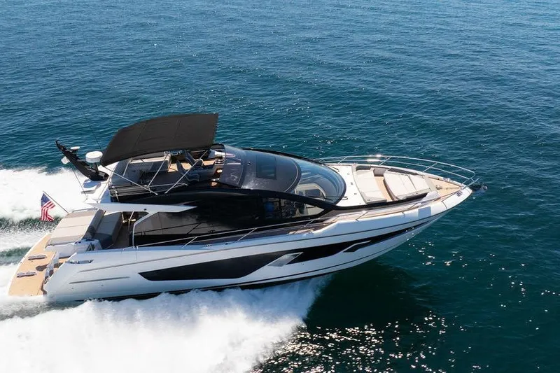  Yacht Photos Pics 2023 Sunseeker 65 Sport Yacht cruising on open water, showcasing sleek design and luxury.