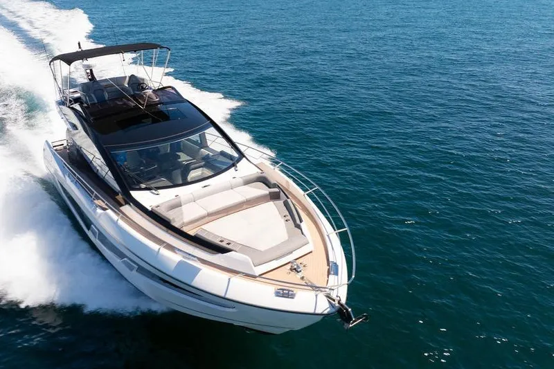  Yacht Photos Pics 2023 Sunseeker 65 Sport Yacht cruising on open water, showcasing sleek design and luxury.
