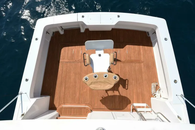 Happy Ending Yacht Photos Pics Viking 55 Convertible 2000 yacht cockpit with teak flooring and fishing chair.
