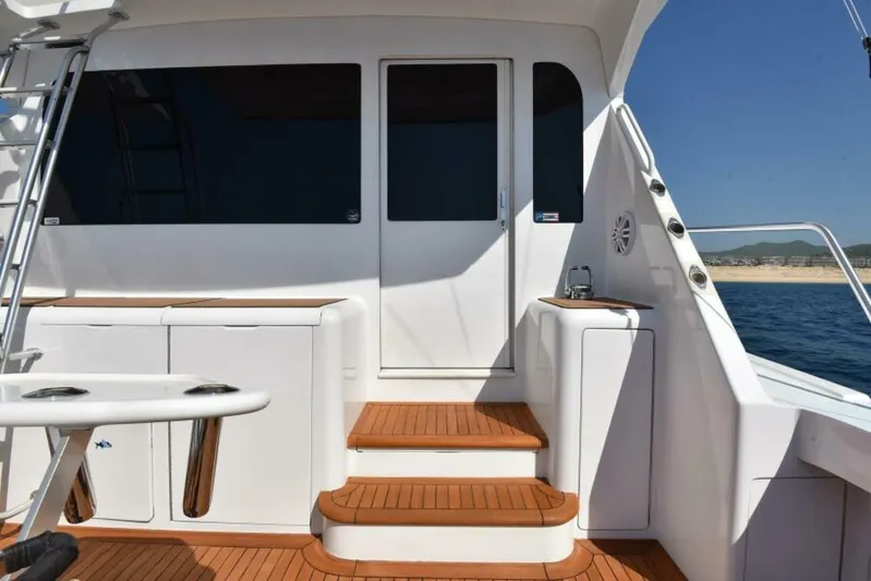 Happy Ending Yacht Photos Pics Viking 55 Convertible 2000 yacht deck with wooden steps and ocean view.