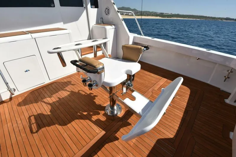 Happy Ending Yacht Photos Pics Fishing chair on 2000 Viking 55 Convertible yacht deck, overlooking ocean.