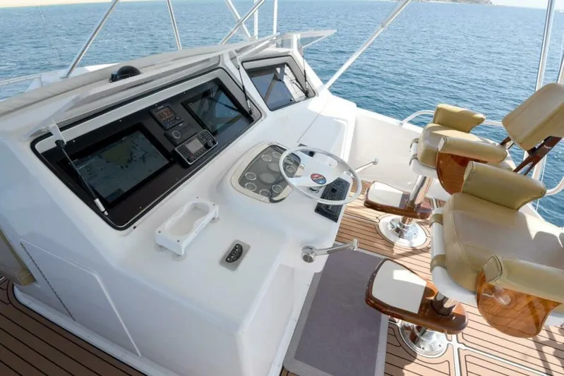 Happy Ending Yacht Photos Pics Helm of 2000 Viking 55 Convertible yacht with dual seats and navigation controls.